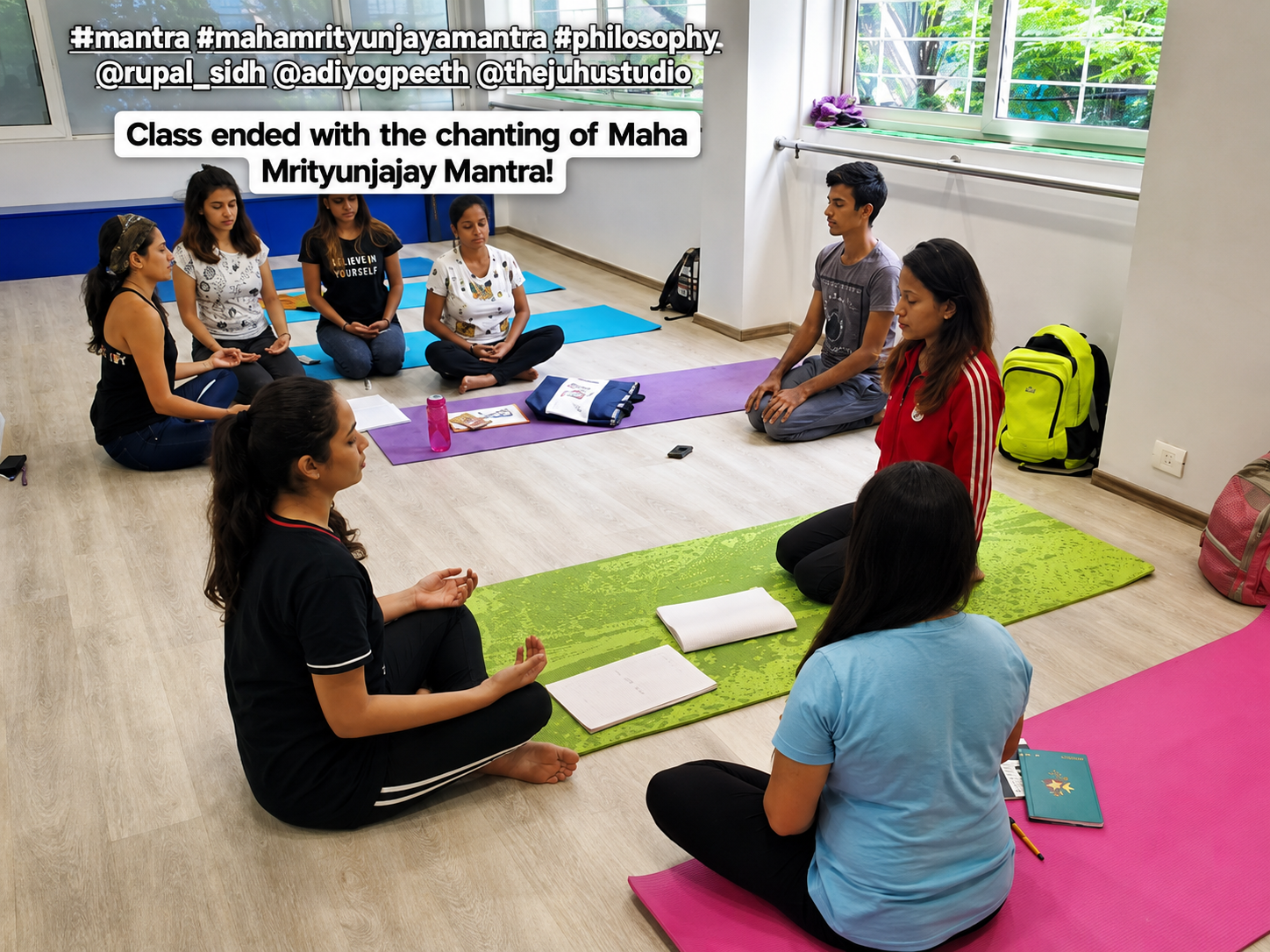 Trainees seated together on colorful mats indoors