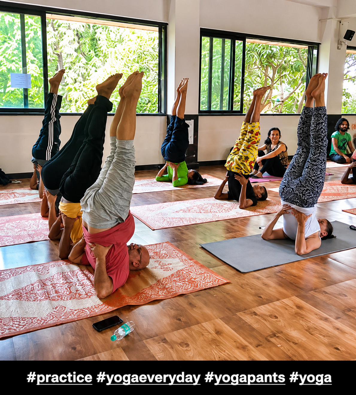 Trainee practicing a supported inversion pose indoors