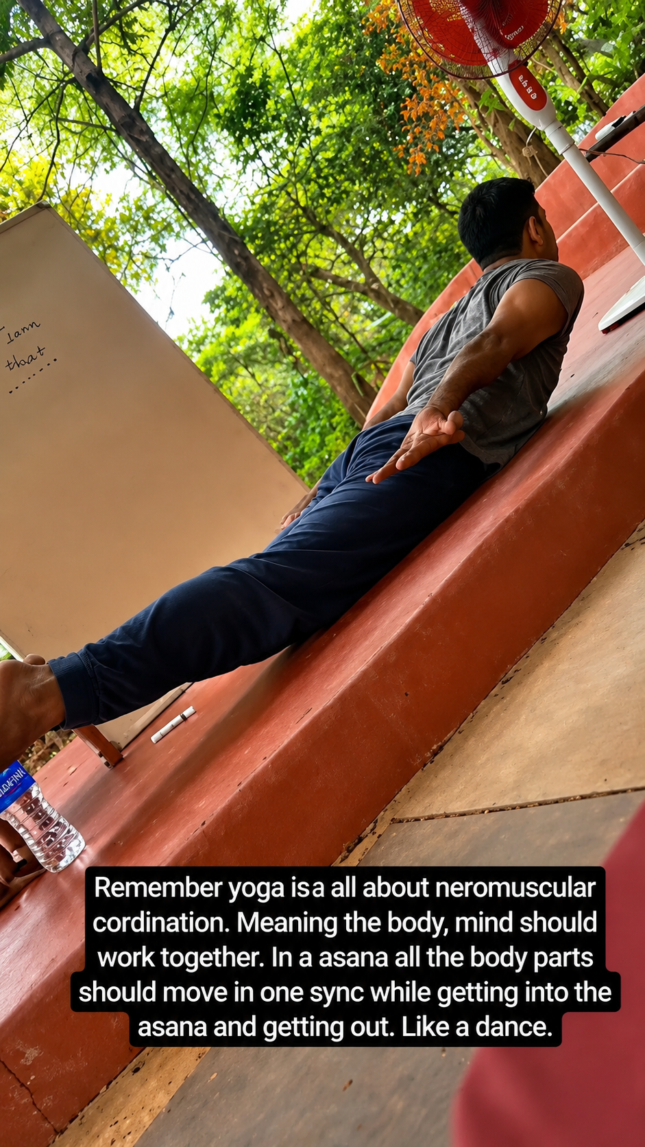 Trainee practicing an inversion pose on an outdoor structure