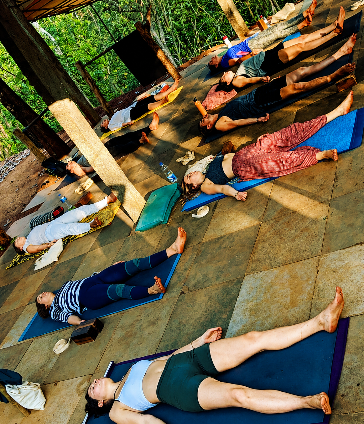 Overhead view of trainees practicing savasana together
