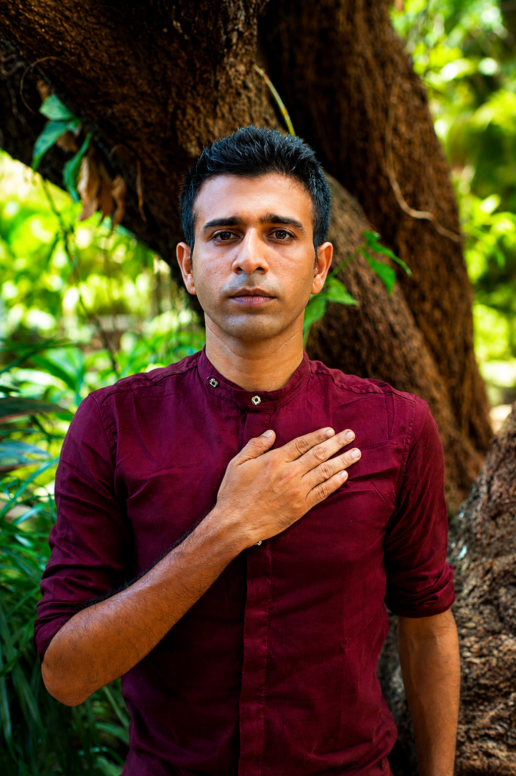 Amogh Shinde holding a traditional broom, playful portrait