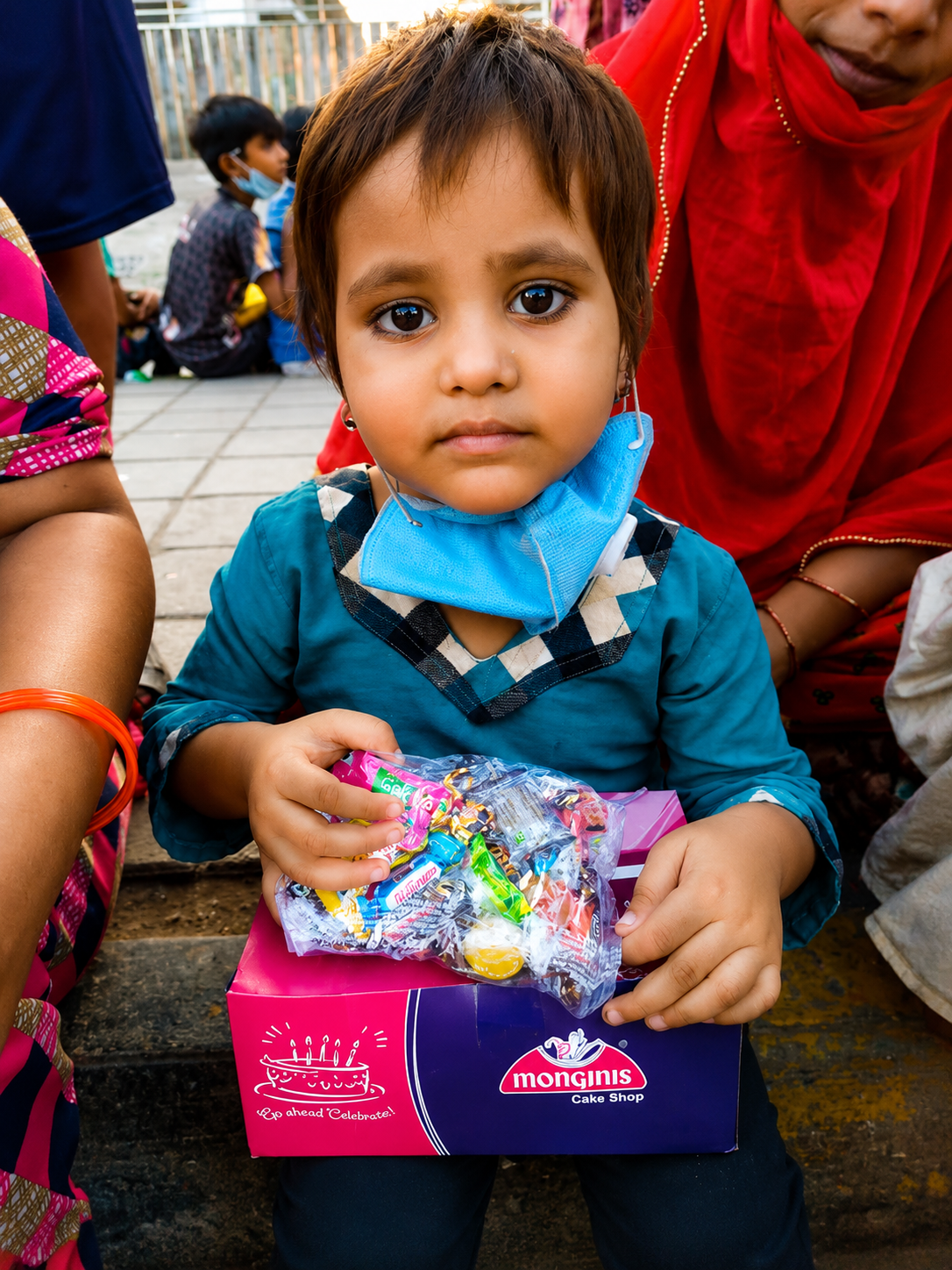 Volunteer holding a young child during an outreach visit