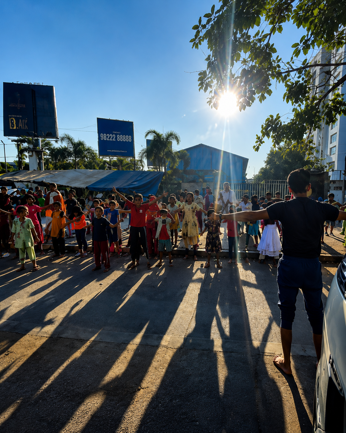 Crowd of volunteers and community members at sunset during an event