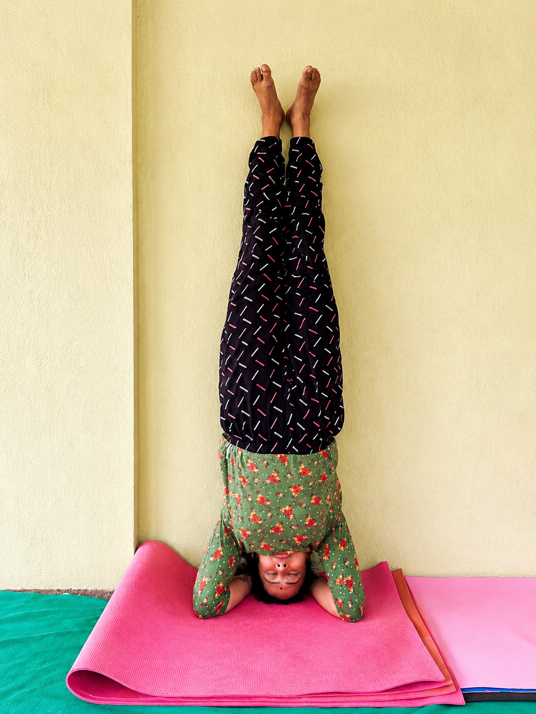 Student practicing supported headstand pose
