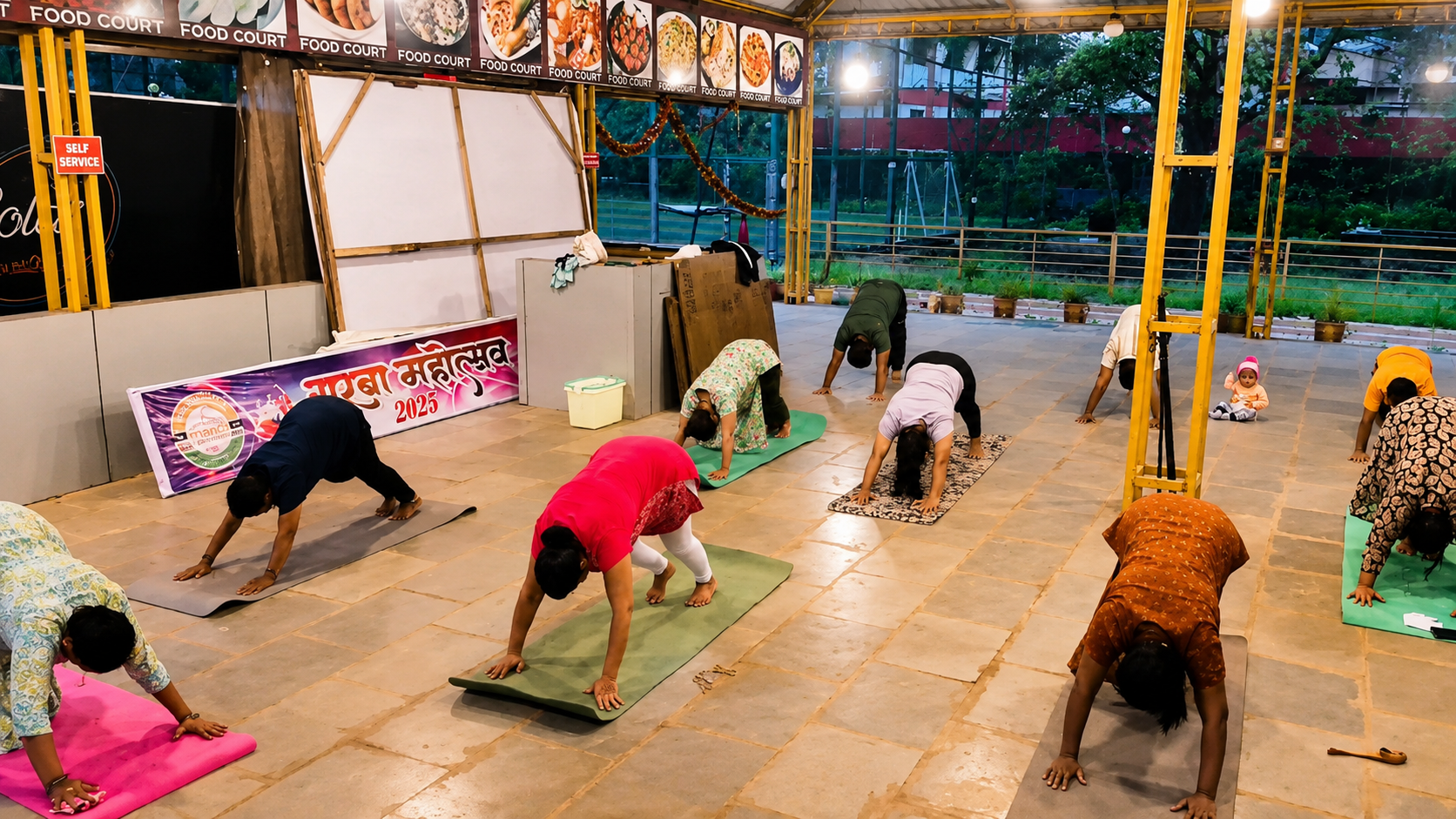 Group yoga class practicing on an outdoor courtyard