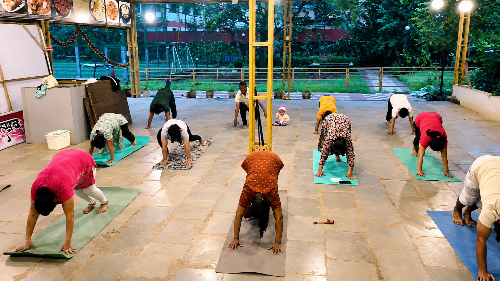 Group yoga class in the courtyard, wide view