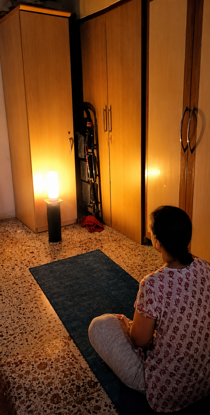 Participant seated in meditation in a dimly lit room