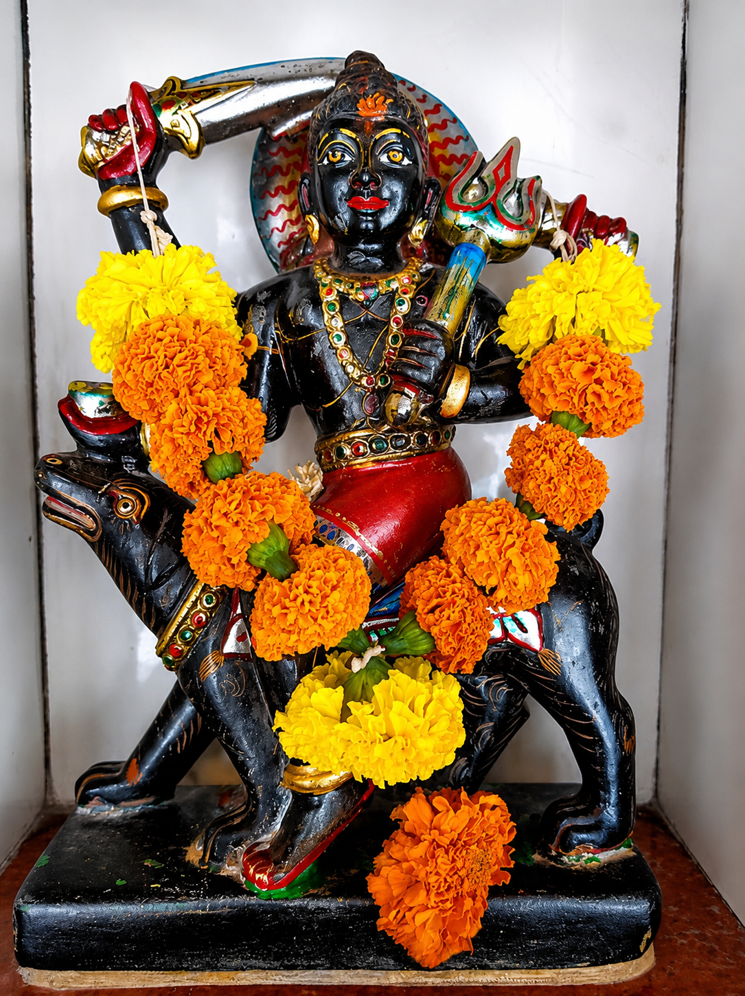 Kali idol shrine adorned with marigold garlands