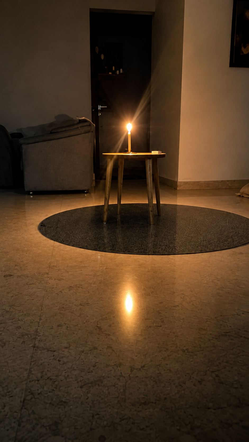 Oil lamp flame reflected in a water bowl