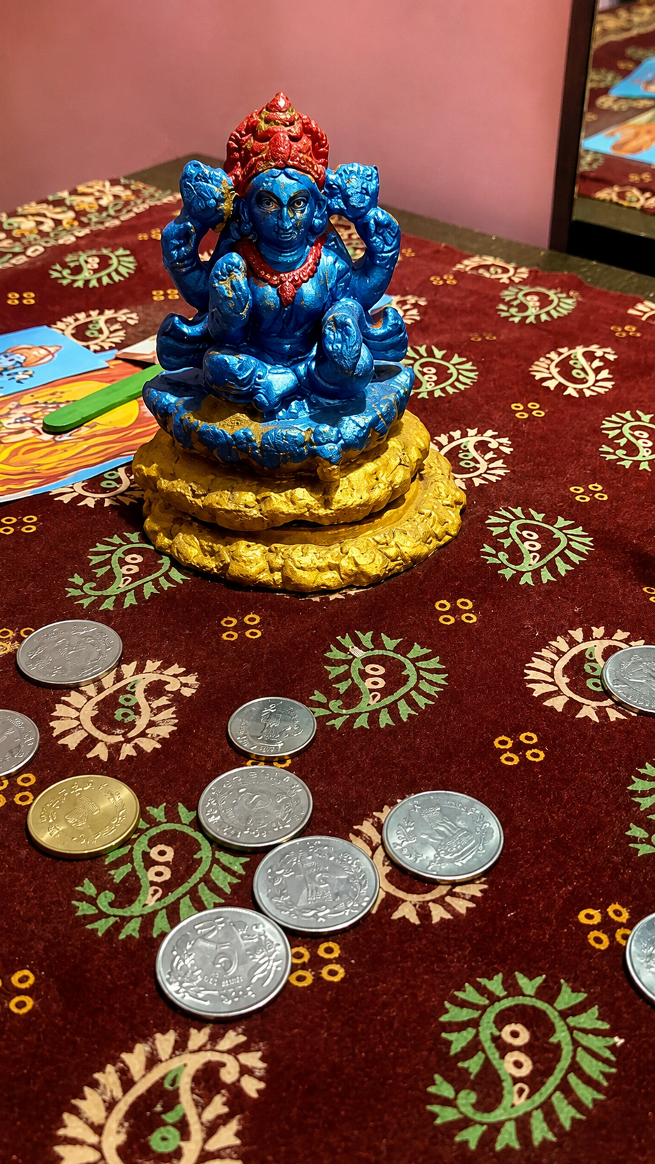 Colourful puja items arranged on a decorated mat