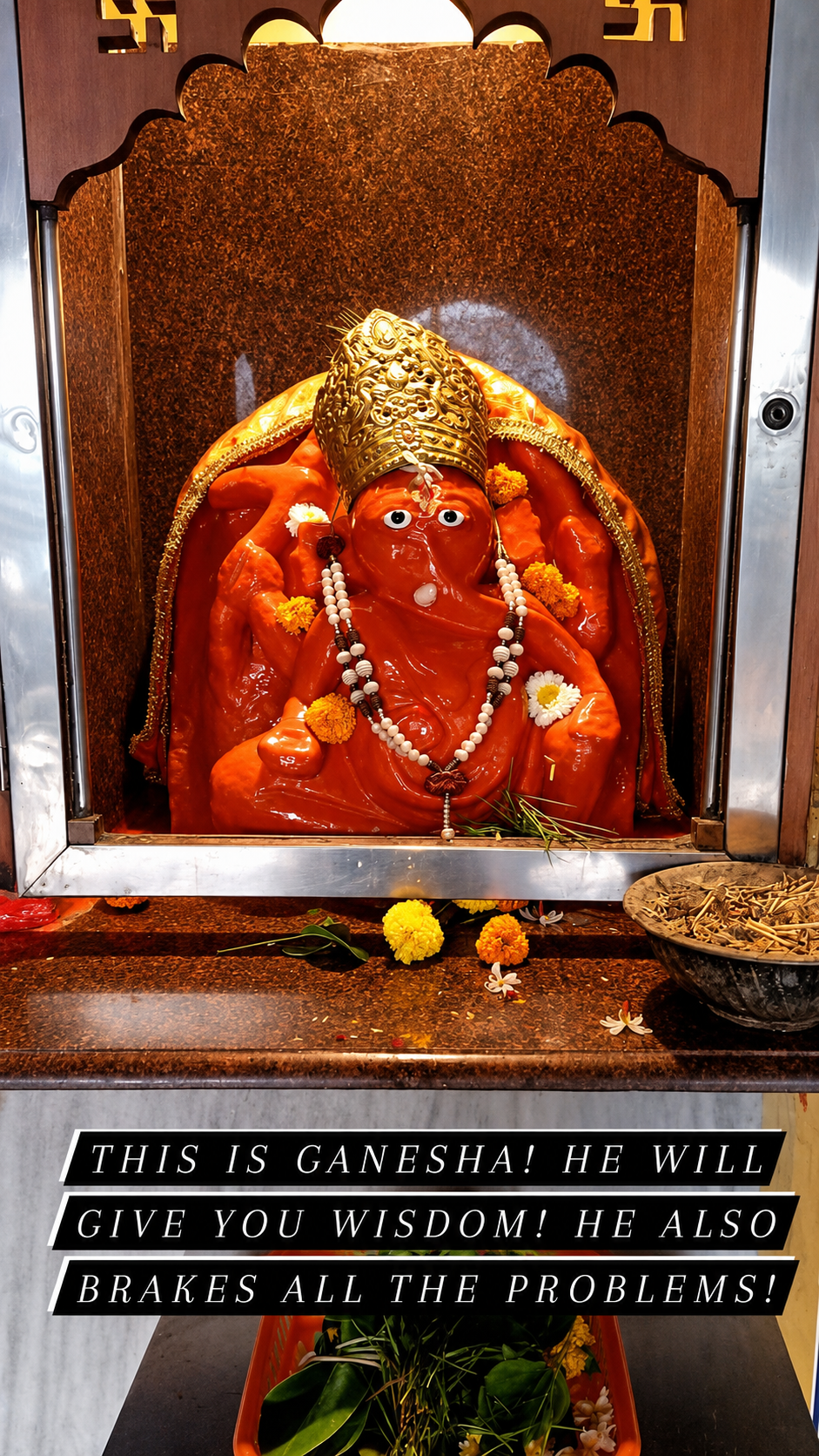 Deity idol in an ornate red-toned shrine