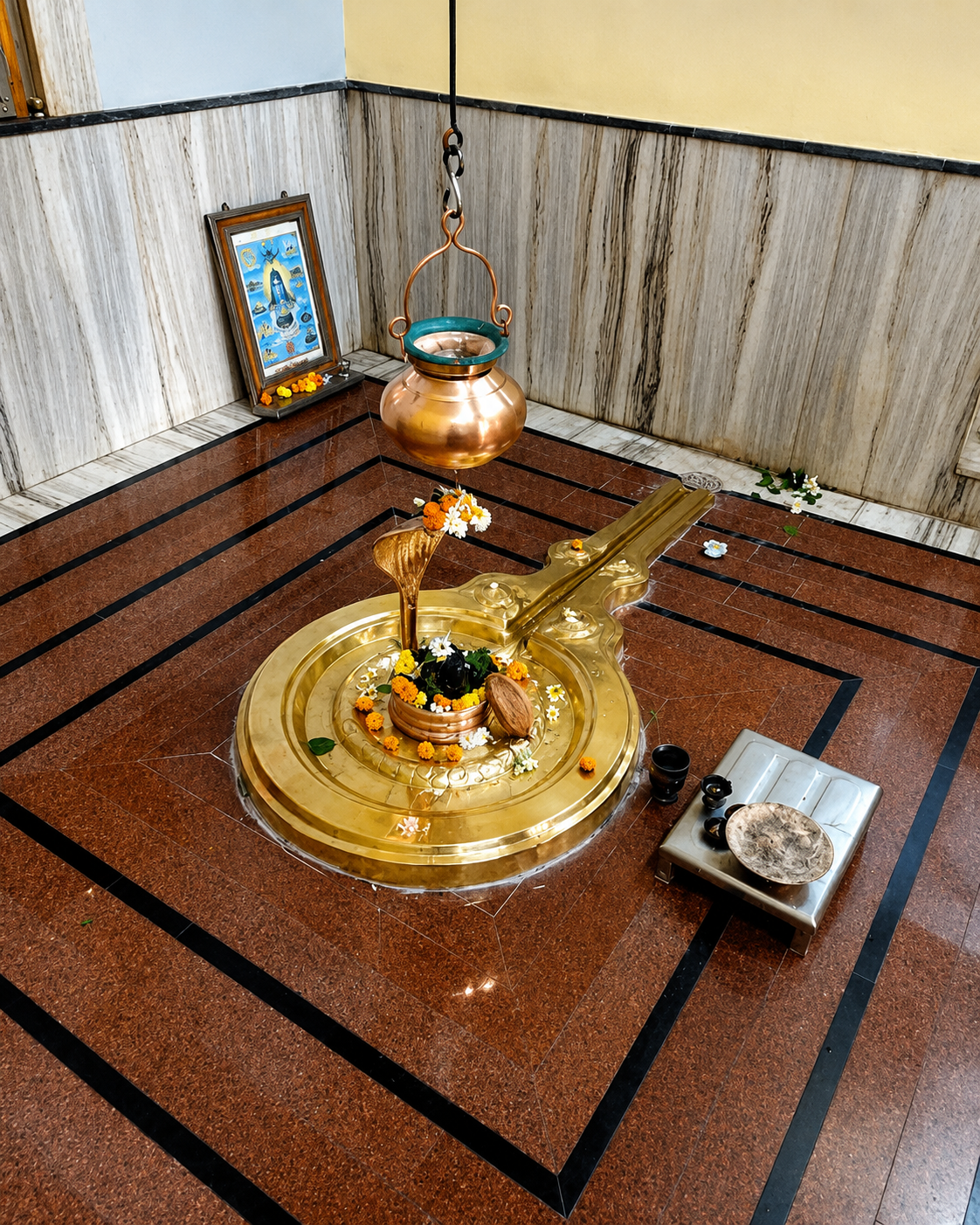 Brass puja lamp and bell set on a wooden table