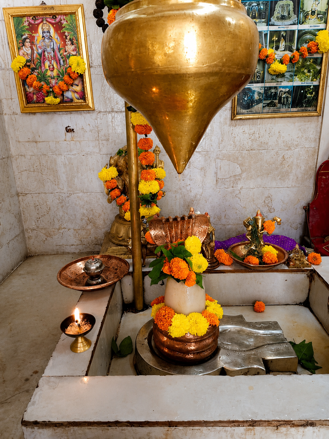 Brass ceremonial lamp with flowers on the altar